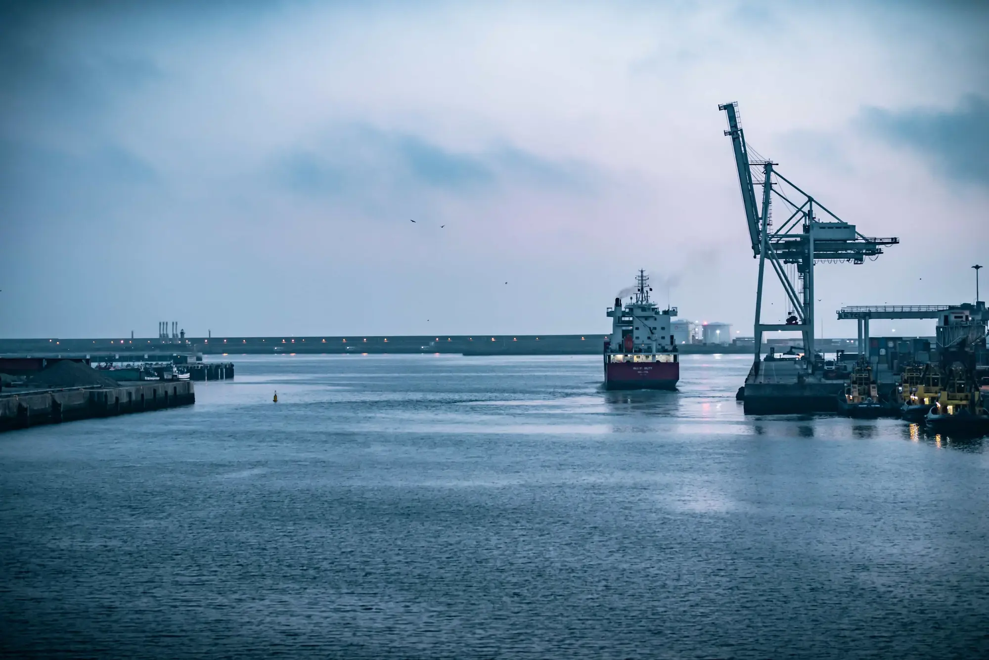 Ships in a picturesque harbor with serene waters and scenic surroundings